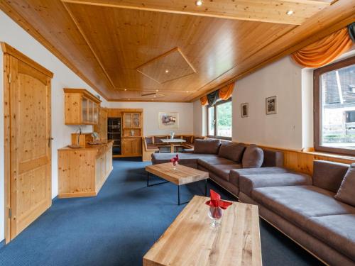 a living room with a couch and a table at Mooshäusl in Hopfgarten im Brixental