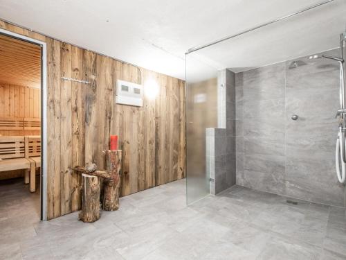 a bathroom with a shower with a glass door at Mooshäusl in Hopfgarten im Brixental