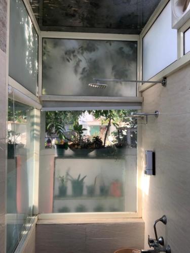 a window in a room with potted plants in it at Green Serene Abode in Meerut