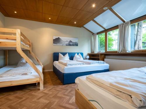 a bedroom with two bunk beds and a window at Gaisbergblick XXL in Kirchberg in Tirol