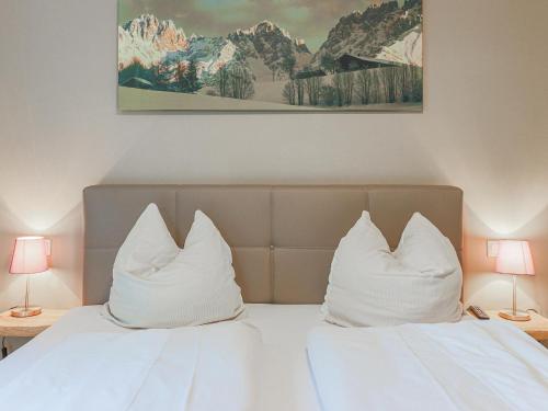 twee kussens op een bed met twee lampen bij Schönfeld I in Kitzbühel