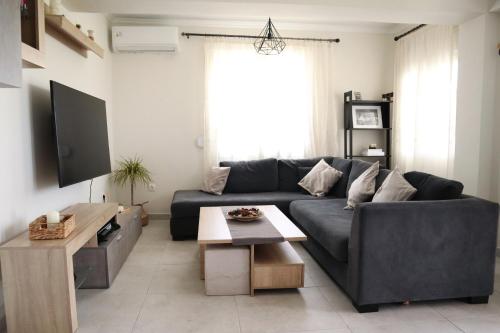 a living room with a couch and a table at Aelia Summer House in Samos