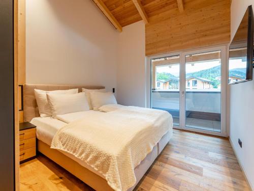 a bedroom with a bed and a large window at Luxury Sankt Lorenzen in Sankt Lorenzen ob Murau