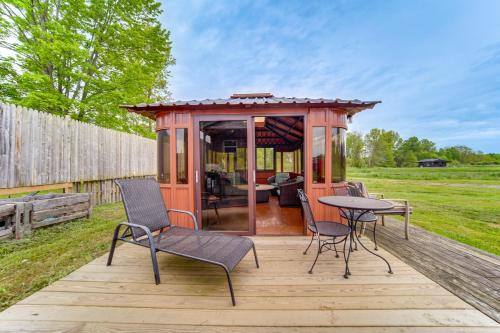 a gazebo with chairs and a table on a deck at Dog-Friendly Cabin Near Pymatuning Lake! in Williamsfield