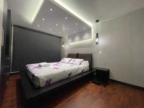 a bedroom with a bed with a large window at ItsaHome Apartments - Torre Aqua in Quito