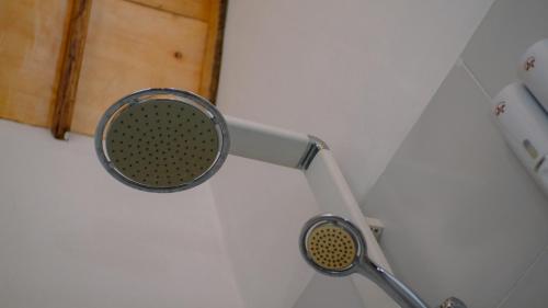 a mirror hanging on a wall in a bathroom at Novia Guest House Lombok-Tetebatu in Tetebatu