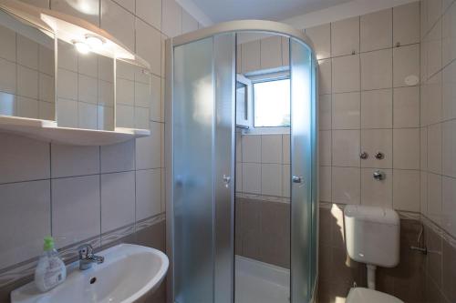 a bathroom with a shower and a sink and a toilet at Apartments by the sea Razanj, Rogoznica - 2970 in Rogoznica