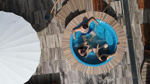 an overhead view of two people in a swimming pool at Elephantia Spa Hotel in Villa de Leyva