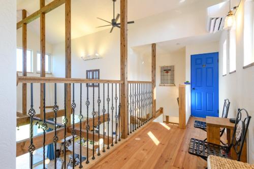 a staircase in a house with a blue door at ZARATAN in Motobu