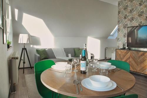 a dining room table with a bottle of wine on it at No2 by 21 Apartments in Kaarst