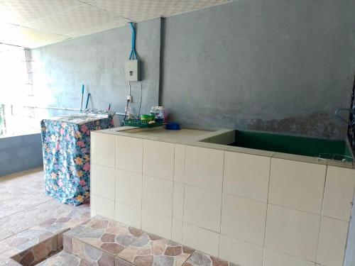a kitchen with a sink and a counter top at Abril hospedaje in Juayúa
