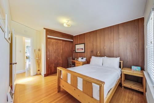 a bedroom with a bed and a wooden wall at Spacious 2br Near Ocean & Sutro Heights Park in San Francisco