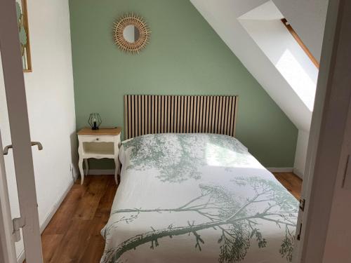 a bedroom with a bed and a mirror on the wall at Duplex 3 Pièces Proche Plage à Cabourg, 6 Pers., Parking Privé - FR-1-487-280 in Varaville