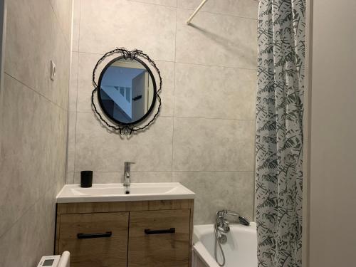 a bathroom with a sink and a mirror and a tub at Duplex 3 Pièces Proche Plage à Cabourg, 6 Pers., Parking Privé - FR-1-487-280 in Varaville