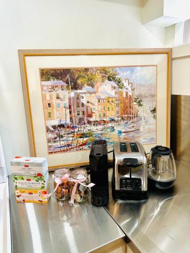 a kitchen counter with a painting of a city at Cozy & Bright Home With Parking in Victoria