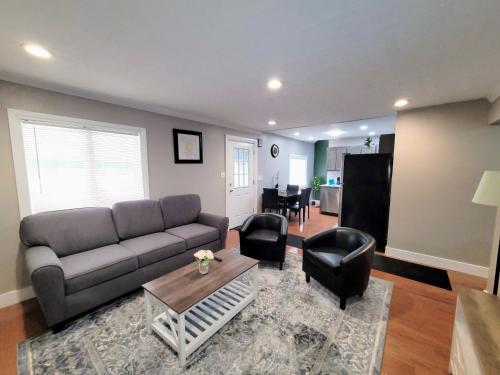 a living room with a couch and a table and chairs at Sweet home, King bed, backyard and parking in Buffalo