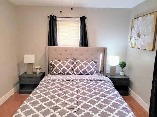 a bedroom with a large bed with two night stands at Sweet home, King bed, backyard and parking in Buffalo