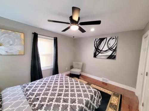 a bedroom with a ceiling fan and a bed at Sweet home, King bed, backyard and parking in Buffalo