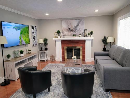 a living room with a couch and a fireplace at Sweet home, King bed, backyard and parking in Buffalo