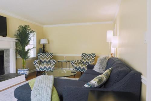 a living room with a blue couch and chairs at The Cardinal Cape in High Point