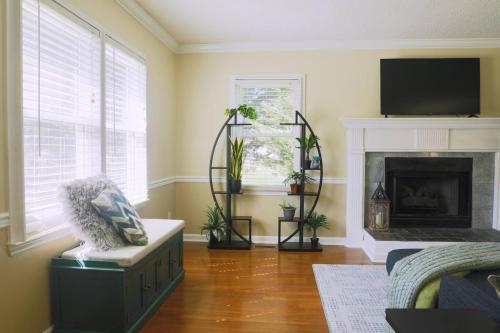 a living room with a fireplace and a tv at The Cardinal Cape in High Point