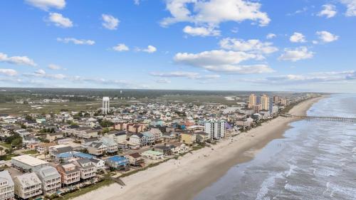 an aerial view of a beach with condos and the ocean at Cherry Grove efficiency just steps from the beach in Myrtle Beach