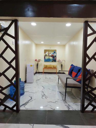 a living room with a bed and a couch at T&J Guest House in Rauis
