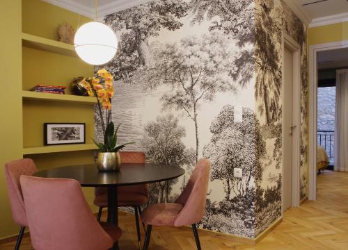 a dining room with a black and white wall mural at Absolute Athens Acropolis View in Athens