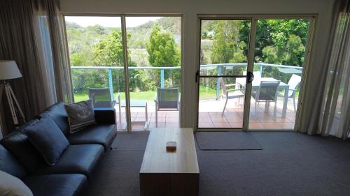 a living room with a couch and a coffee table at BlueWater Apartments in Merimbula
