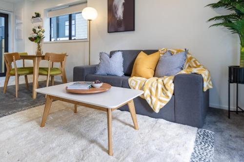 a living room with a couch and a table at Prime Location: Hagley, Riverside, Hospital in Christchurch