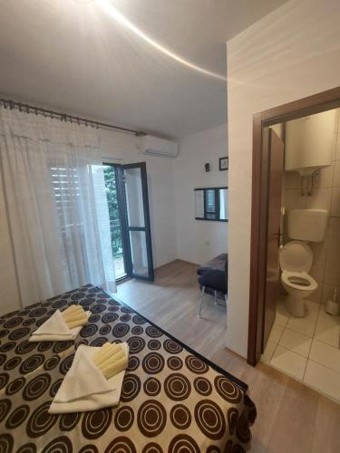 een slaapkamer met een bed en een badkamer met een toilet bij HOLIDAY ROOM - THE VIEW in Novi Vinodolski