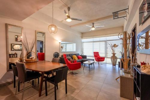 a dining room and living room with a table and chairs at Nayarit Coastal Retreat New Luxury Haven in Nuevo Vallarta