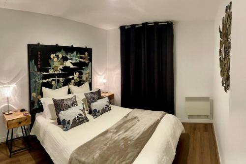 a bedroom with a large bed with pillows on it at Fitzroy Zen in Melbourne