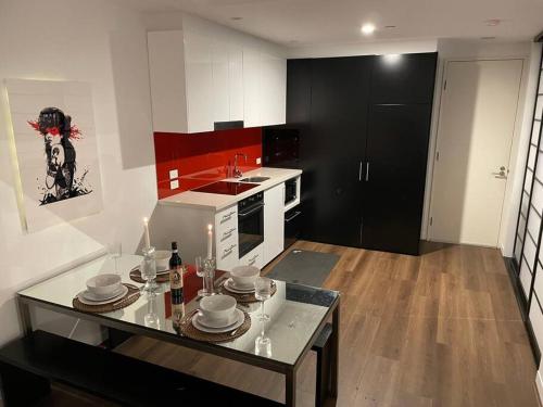 a kitchen with a table with dishes on it at Fitzroy Zen in Melbourne