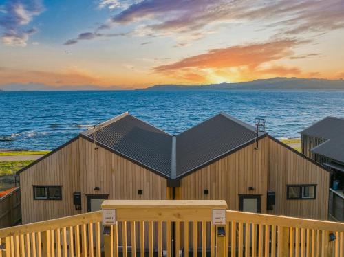 a wooden building with a view of the ocean at Absolute Lakefront House in Taupo