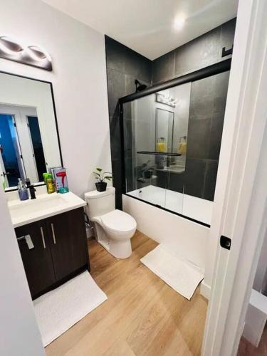 a bathroom with a toilet and a sink and a shower at B19 Modern Stylish 2bed Basement Suite in Edmonton
