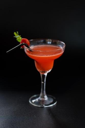 a drink in a glass with a strawberry in it at d'kamala by Prasi in Ubud