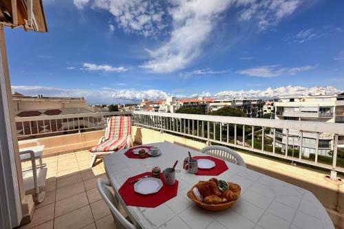 une table avec un bol de nourriture sur un balcon dans l'établissement LE MATHILDE - Appart 1 chambre Vue dégagée proche de la plage avec parking, au Grau-du-Roi