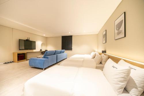 a hotel room with a bed and a couch at Hotel LeeSunDeok in Busan
