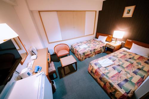 En eller flere senger på et rom på Plaza Hotel Nogata