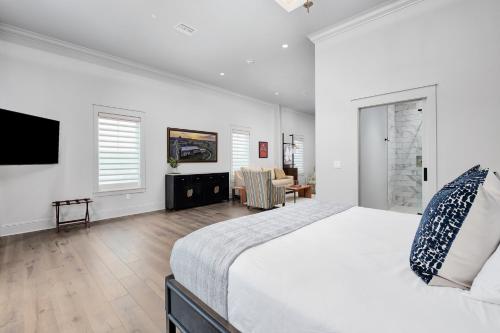 a bedroom with a large bed and a living room at The Flying Fifty Hotel, a Luxury Boutique Hotel in Cullman