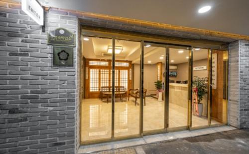 an entrance to a building with glass doors at Hotel LeeSunDeok in Busan