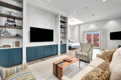 a living room with a couch and a tv at The Flying Fifty Hotel, a Luxury Boutique Hotel in Cullman