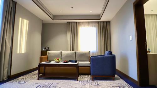 a living room with a couch and a table at Five Seasons Hotel in Tabuk