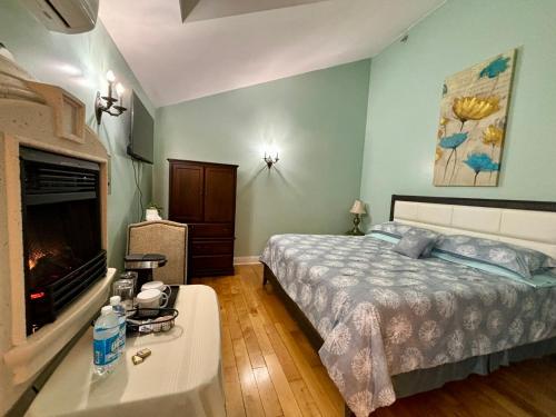 a bedroom with a bed and a fireplace at Inn on the Harbour in Charlottetown