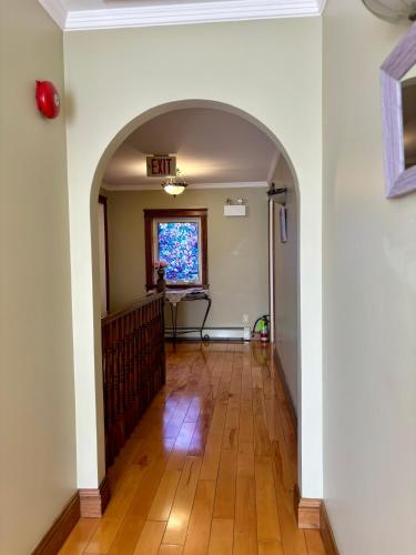 an empty hallway with an archway in a house at Inn on the Harbour in Charlottetown