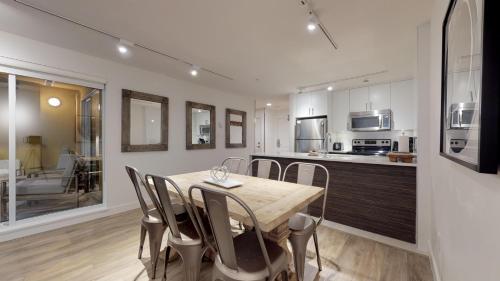 a kitchen and dining room with a table and chairs at Bear Lodge, Whistler Village - Spectacular Location on Village Stroll, Designer Remodel in Whistler