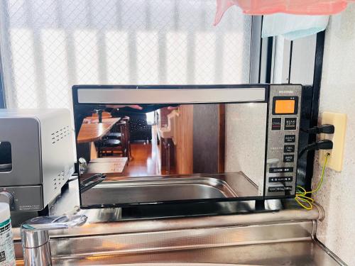 Una cocina o zona de cocina en 鹿児島中央ハウスhana