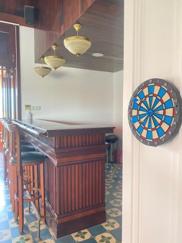 a bar with a dart board next to a bar at OrangeBlue villa near Beach Pool free Vung Tau Vietnam in Vung Tau