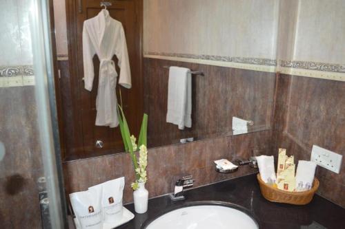 a bathroom with a sink and a mirror at Fort Continental Hotel in Peshawar